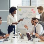 A diverse business team collaborating around a table, brainstorming innovation strategies to unlock growth opportunities