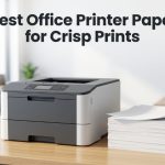 A stack of premium white office paper next to a modern laser printer on a wooden desk.
