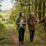 A buyer walking through a privately owned mixed woodland plot in rural England, representing the UK recreational land market in 2026